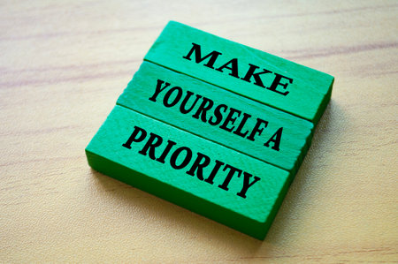 Make yourself a priority text on green color wooden blocks. Aspiration quoteの写真素材