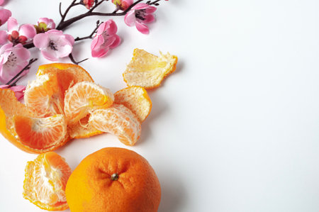 Top view of Mandarin oranges on white background with customizable space for text or wishes. Chinese...