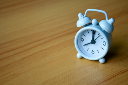 Table alarm clock pointing at 8 am with space for text. Time concept and copy space.