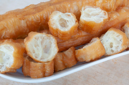 Close up of cut cakoi or youtiao cake on white plate. Asian food conceptの写真素材