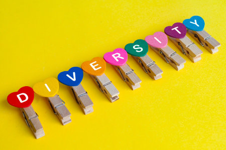 Diversity text on hearth shape on yellow background.の写真素材