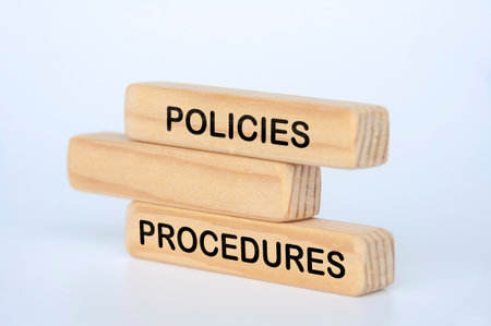 Policies and procedures text on wooden blocks.の写真素材
