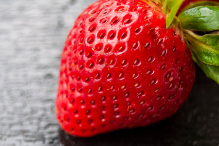 Close up of strawberry on black cover background. Healthy food and fruits conceptの写真素材
