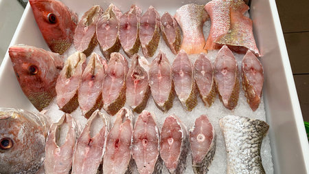 Slices of red snapper fish displayed in supermarket. Fresh seafood concept.
