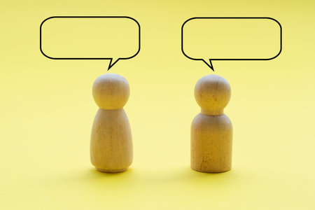 Two wooden figure with customizable space on speech bubble.