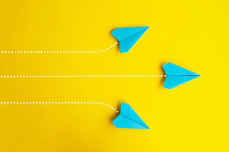 Blue paper airplanes flying on a separate directions.