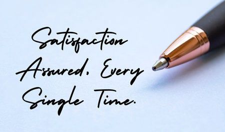 Satisfaction assured, every single time text with close up pen background. Business strategy and...