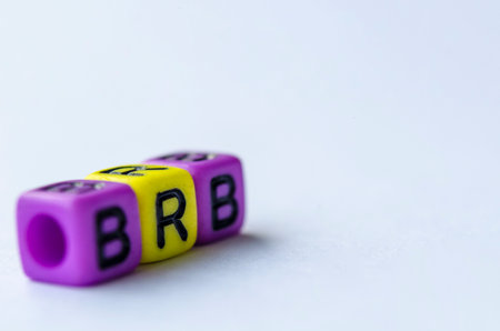 BRB text representing Be Right Back on small square toy on white background. Break time concept.の写真素材