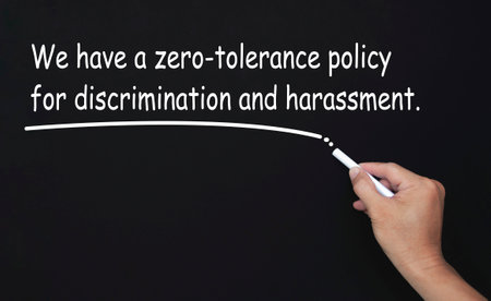 We have a zero-tolerance policy for discrimination and harassment text written on blackboard.の写真素材