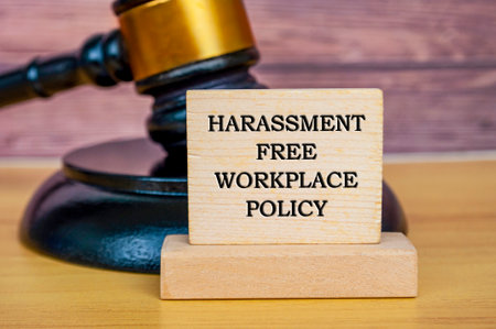Harassment free workplace policy text written on wooden board with gavel background. Safe workplace concept.の写真素材