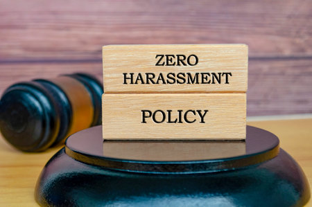 Zero Harassment Policy text written on wooden blocks with gavel background. Safe workplace concept.の写真素材