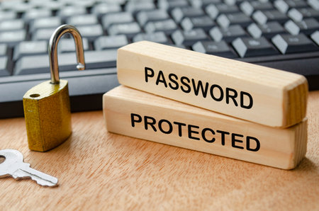 Password protected text on wooden blocks with padlock and laptop keyboard background. Password security concept.の写真素材