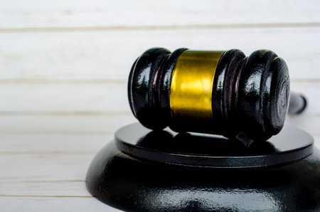 Lawyer's gavel on white wooden background with customizable space for text. Law and copy space...