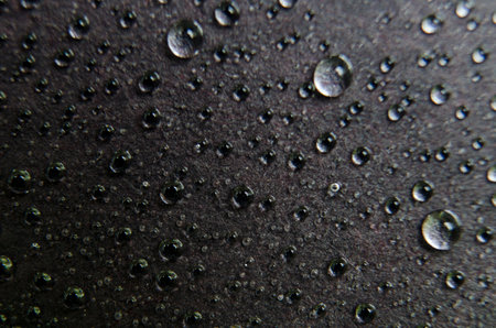 Close up of water droplets on dark background. Water droplets and wallpaper concept.の写真素材