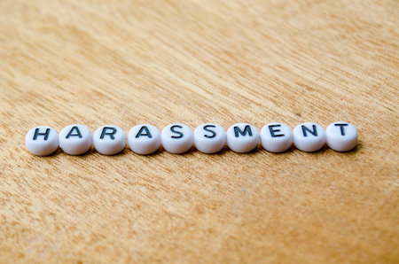 Harassment text on wooden table.の写真素材