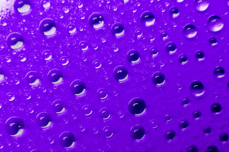 Close up of water droplets on dark blue cover background. Water droplets and wallpaper design conceptの写真素材