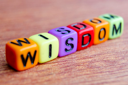 Close up of wisdom text on wooden table.の写真素材