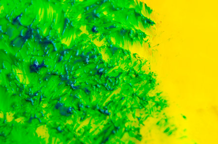 Top view of green watercolor brush stroke on yellow background