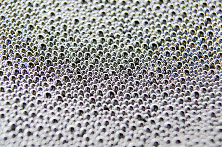 Top view of Macro shot of bubbles forming on a water surface with dark background.の写真素材
