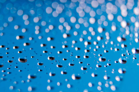 Water drops on blue background. Abstract macro photo of water drops.