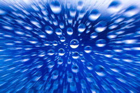 Zooming into clear raindrops on clear glass.