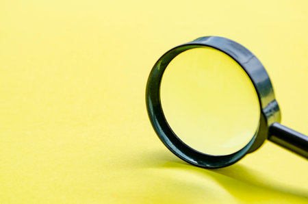 Side view of close up of magnifying glass with customizable space for text or ideas.の写真素材