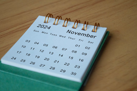 Side view of November 2024 calendar on wooden desk. Calendar concept.の写真素材