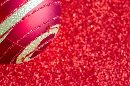 Close up view of Christmas ball on red background with customizable space for text or for wishes. Christmas celebration concept.の写真素材