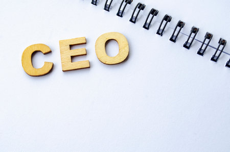 CEO wooden letters on white notepad. CEO representing Chief Executive Officer.の写真素材