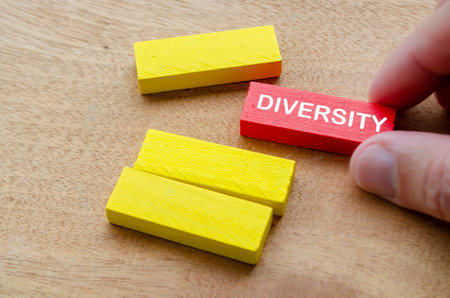 Diversity text on red wooden block with yellow wooden blocks.の写真素材