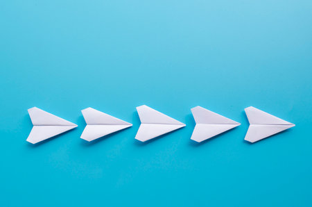 Top view of origami white paper airplanes with customizable space for text.の写真素材