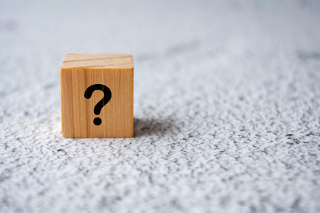 Isolated question mark on white marble background. Question and Answer concept.の写真素材