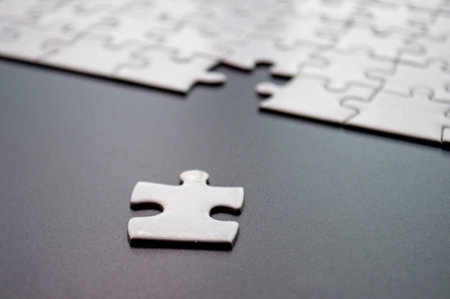 Close up view of separated jigsaw on dark cover background.の写真素材