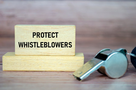 Protect Whistleblowers text on wooden blocks with whistle background.の写真素材