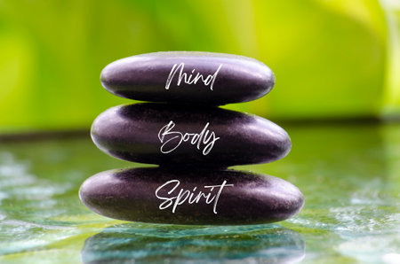 Mind Body and Spirit ext on black zen stones. Inner peace concept.の写真素材