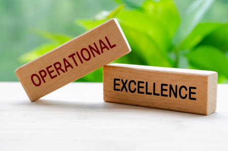 Operational Excellence text on wooden blocks. Continuous Improvement concept.の写真素材