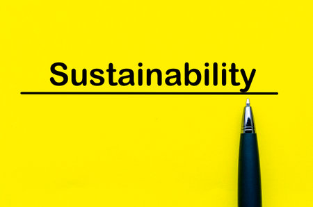 Sustainability text written on yellow cover backgroundの写真素材