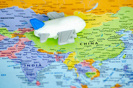 Small toy airplane placed on a world map representing travel or global exploration. Travel and destination concept.の写真素材