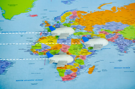 Small toy airplanes on world map representing travel or global exploration. Travel and destination...