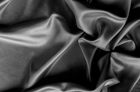 Top view of dark satin fabric with rich texture and smooth, elegant folds. Suitable for design and wallpaper background.の写真素材