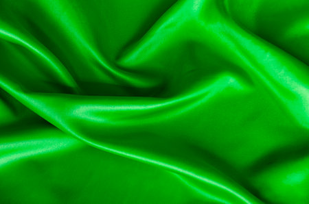 Polished dark green silk cloth with silky sheen and beautiful natural draping. Suitable for design and wallpaper background.の写真素材