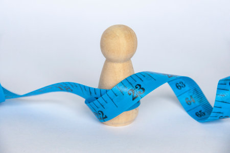 Blue measure tape wrapping a wooden doll with customizable space for text.