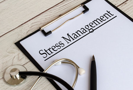 Side view of Stress Management text on clipboard with gavel on top. Mental wellbeing concept.の写真素材