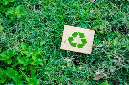 Top view of Recycle symbol on wooden block with customizable space for text. For a greener tomorrow concept.の写真素材