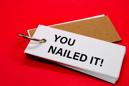 YOU NAILED IT text on white notepad. A Simple Gesture, A Powerful Message of Recognition and Encouragement.の写真素材