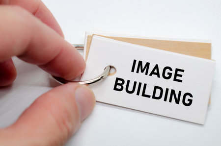Image building slogan on white note suggesting reputation creation and consistent branding practices