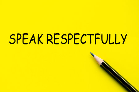 Speak respectfully text on yellow pad with pen representing the value of mindful and dignified communicationの写真素材