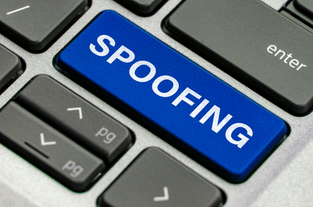 Spoofing text on keyboard showcasing threats of impersonation in digital communications.の写真素材