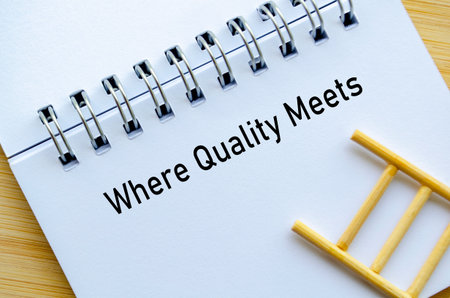 Where Quality Meets representing Your Trust Our Qualities message on notebook with ladder symbolizing growth and confidence.の写真素材