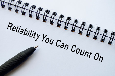 Reliability You Can Count On on notebook with pen representing assurance and trust.の写真素材